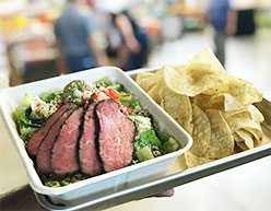 Tri-tip meal with green salad and chips